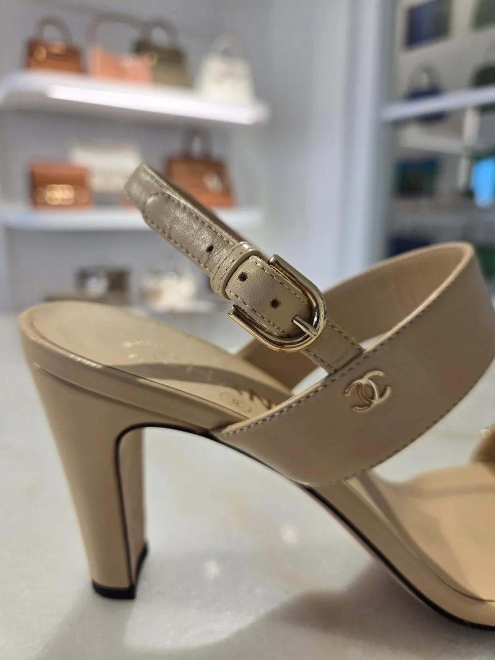 CHANEL Beige Slingback Heels with Black-and-Gold Chain
